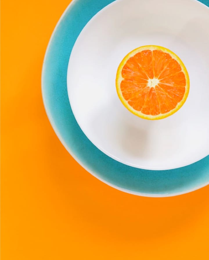 cut orange in a plate